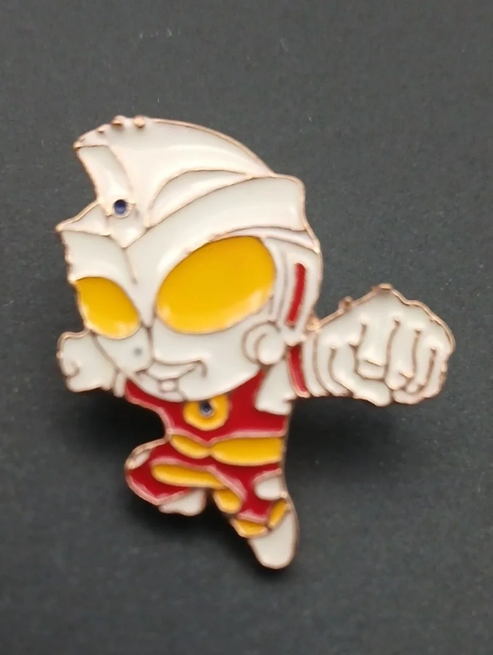 This is a chibi-style Ultraman enamel lapel pin